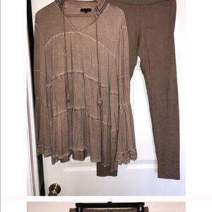 Tan long sleeve blouse with bell sleeves.